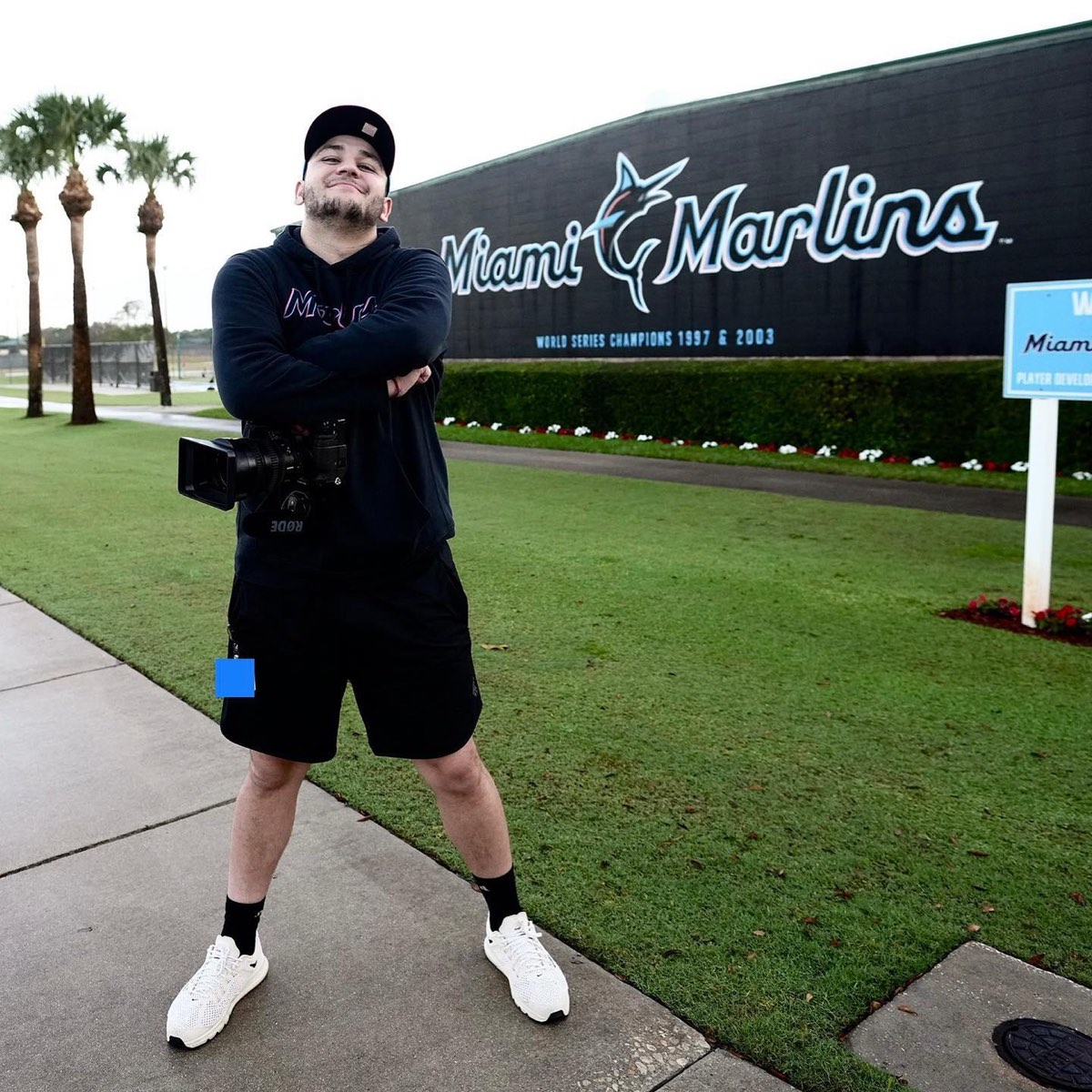 Julian Rosa with a cinema camera in front of the Miami Marlins wall