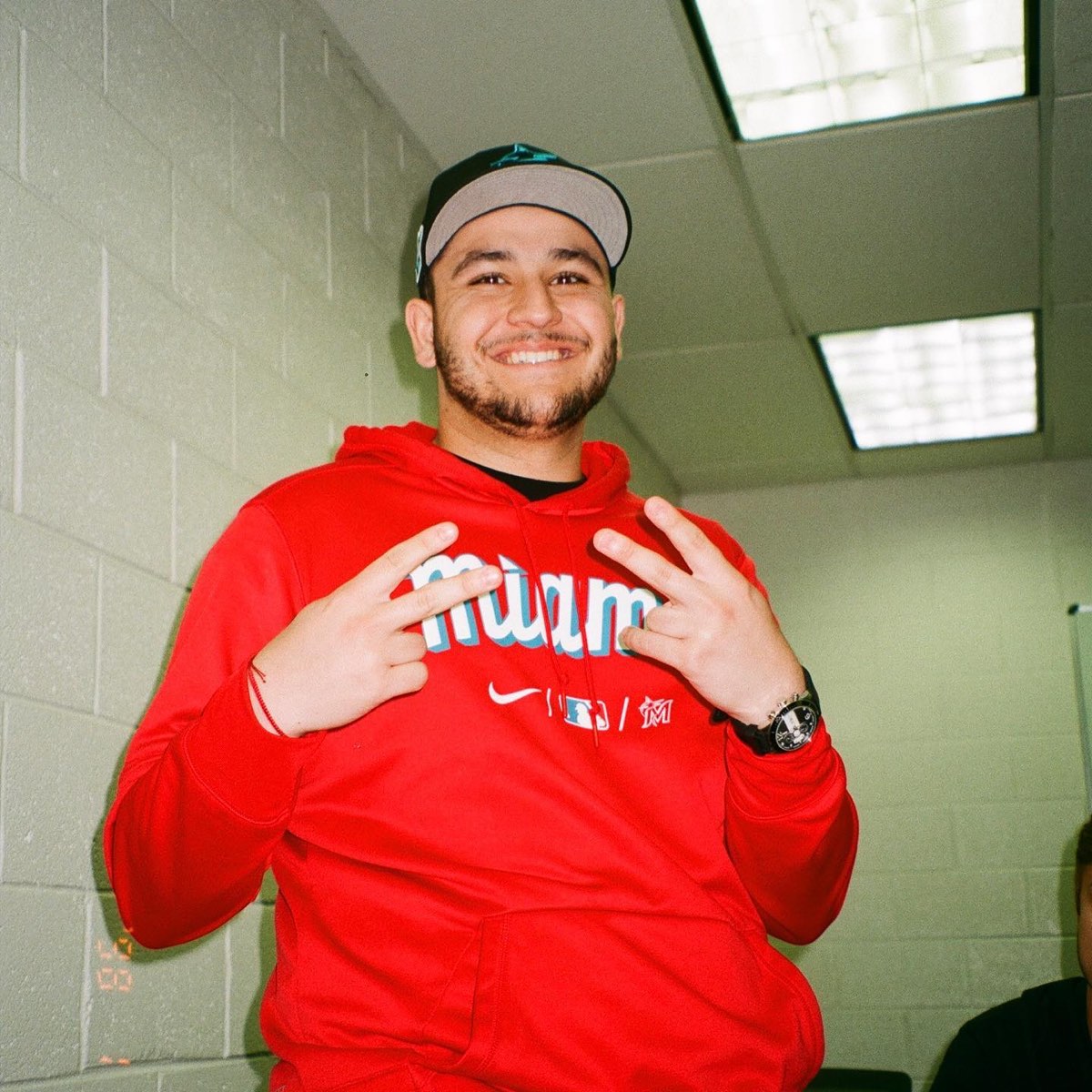 Julian Rosa smiling in a red Miami hoodie